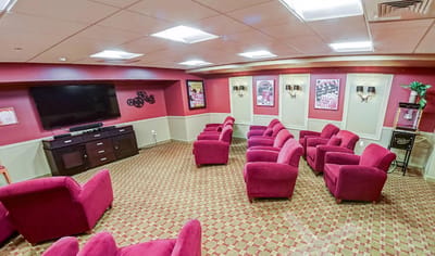 Cozy common area with plush seating and a large TV