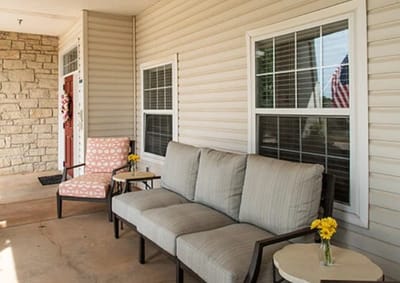 Outdoor seating area with flowers and comfortable chairs