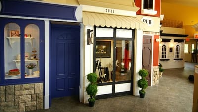 Interior view of a community space with decorative storefronts