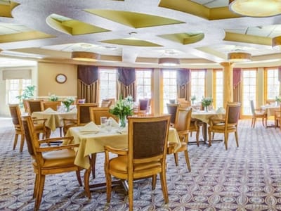 Bright dining room with tables set for meals