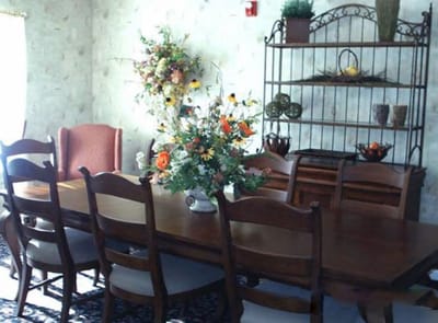 Bright dining room with wooden furniture and floral decor
