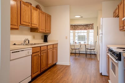 Bright kitchen area with wooden cabinets and dining space