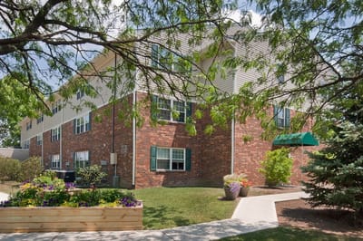 Exterior view of Skybird Manor with greenery and pathways