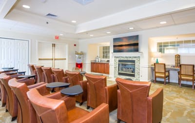 Bright common area with leather seating and a fireplace