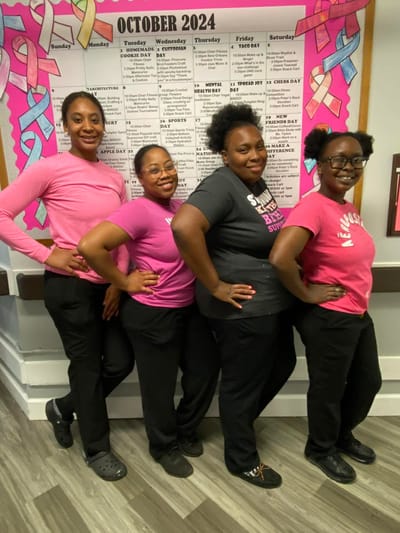 Staff members posing together in colorful shirts