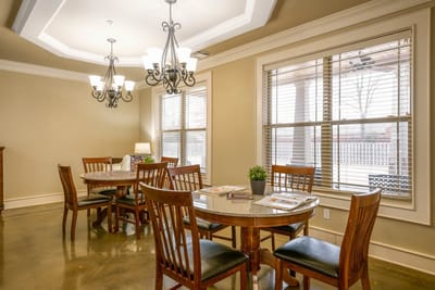 Bright dining room setup with wooden tables and chairs