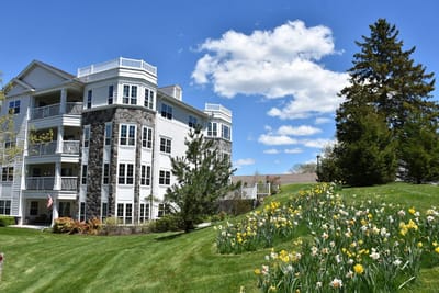 Exterior view of a senior living facility with flowers