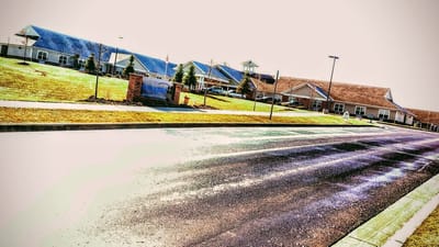 Exterior view of Stonegate Health Campus with landscaped grounds