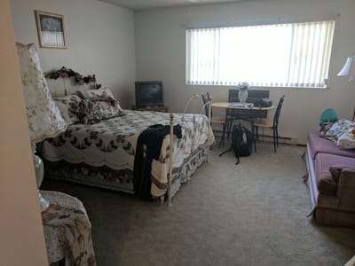 Cozy resident room with a bed and a table