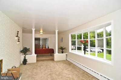Bright interior lobby with seating and flower arrangements
