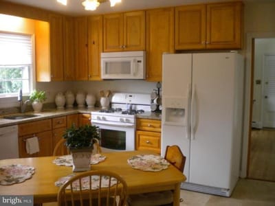 Bright kitchen with wooden cabinets and dining area