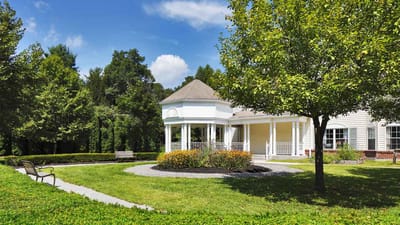 Exterior view of a senior living facility with gardens