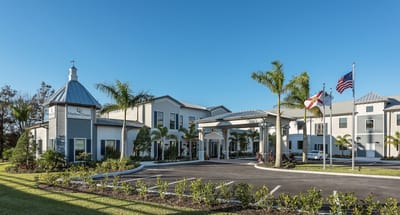 Exterior view of assisted living facility with flags