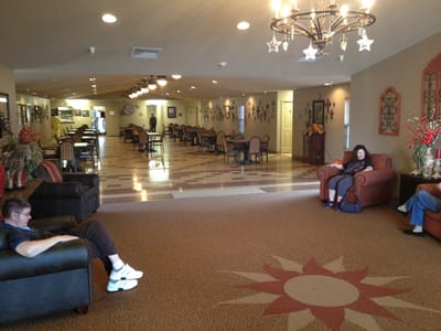 Residents relaxing in a common area with comfortable seating