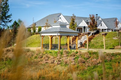 Outdoor gazebo with facility building in the background