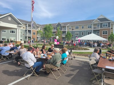 Residents enjoying a community event outdoors with food