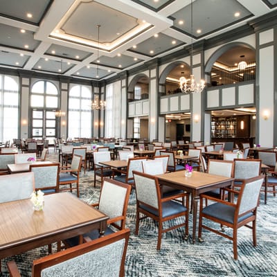 Spacious dining room with tables arranged for residents