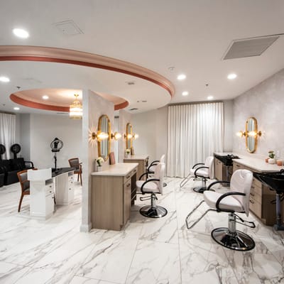 A modern hair salon interior with styling stations