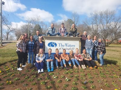 Staff group photo at The Waters of Springfield sign