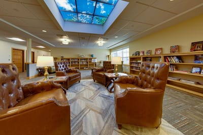 Cozy reading area with leather chairs and bookshelves