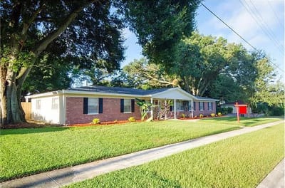 Exterior view of the assisted living facility with landscaped yard