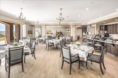 Bright dining room setup for residents with tables and flowers