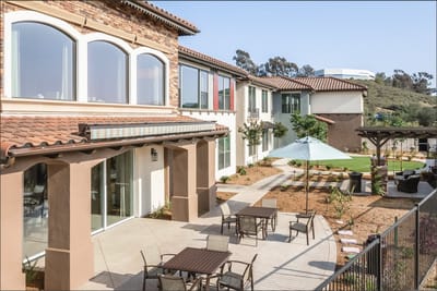 Outdoor seating area with tables and umbrellas
