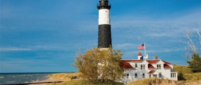 A lighthouse near a sandy beach