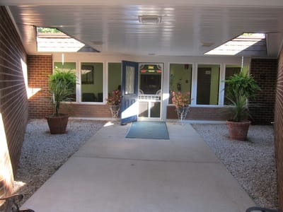 Entrance area of the facility with plants and seating