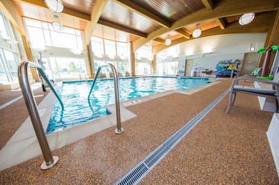 Indoor pool area with natural light and wooden beams