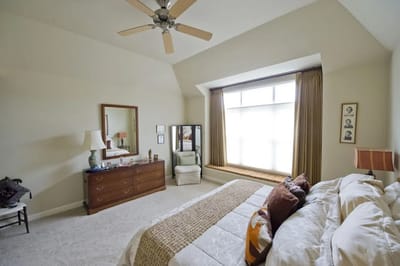 Bright interior of a resident's bedroom with a large window