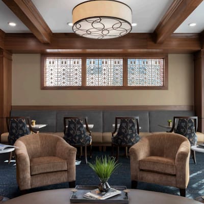 Interior view of a cozy lounge area with chairs and tables