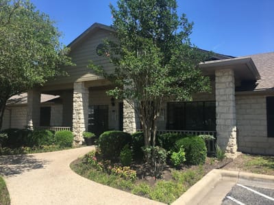 Exterior view of Wells Point Lodge with landscaped garden