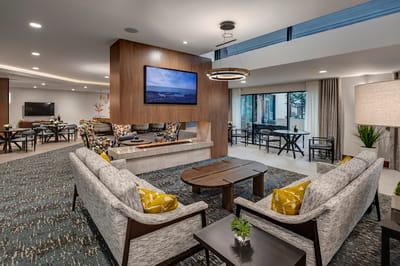 Bright common area with modern furnishings and a television.