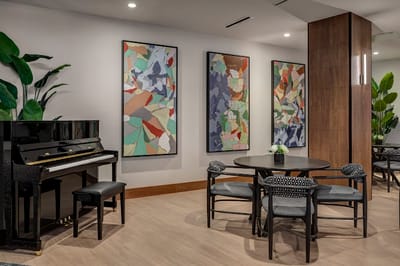 Interior common area with piano and artwork