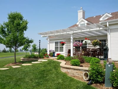 Outdoor seating area with flowers and landscaping