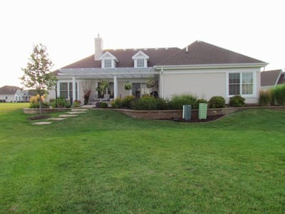 Exterior view of a senior living facility with gardens