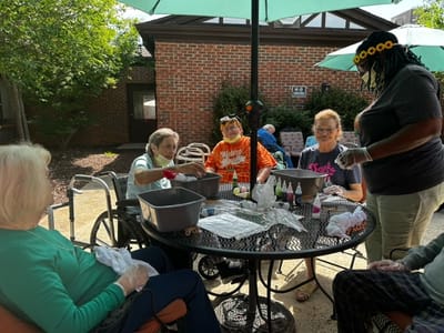 Residents engaging in an outdoor art activity
