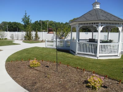 Outdoor space featuring a gazebo and landscaped garden
