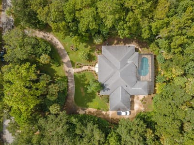Aerial view of a large senior living facility surrounded by trees