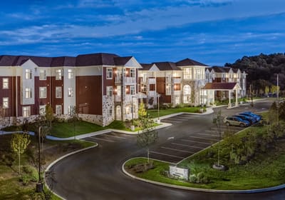 Exterior view of a senior living facility at dusk