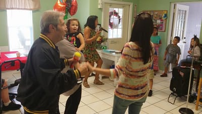 Residents and family enjoying a lively activity indoors