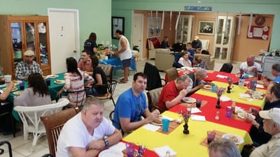 Residents enjoying lunch in a dining room setting