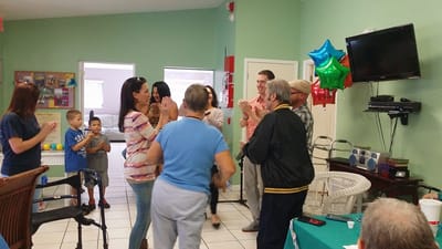 Residents and staff celebrating in a vibrant common area