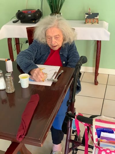 Resident coloring at a dining table in the facility