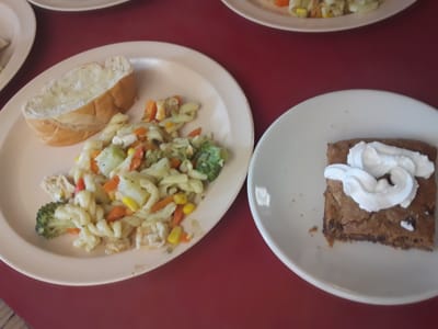 Plated meal with pasta and dessert on a table