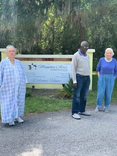 Residents standing in front of the Magnolia Acres sign