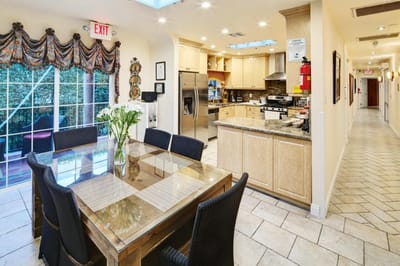 Bright dining area with a view and kitchen