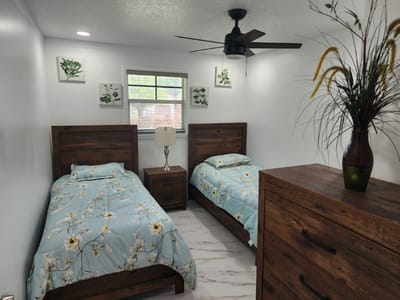 A cozy resident room with two beds and natural decor.