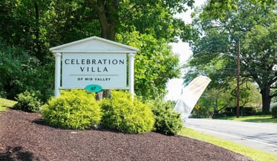 Sign for Celebration Villa of Mid Valley with landscaping